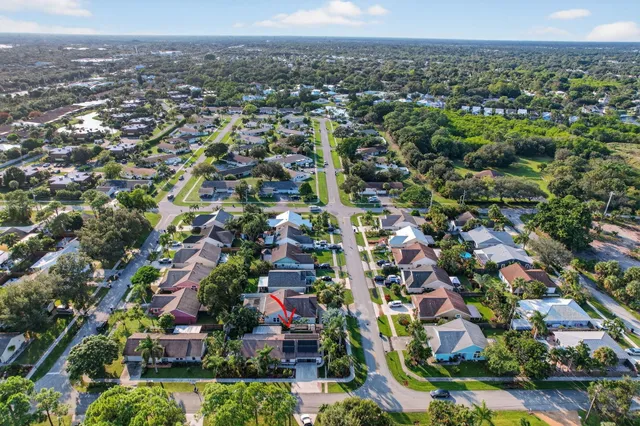 a front view of multi story residential apartment building with a yard
