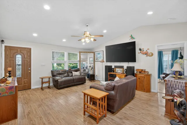 a dining room with furniture a window and wooden floor