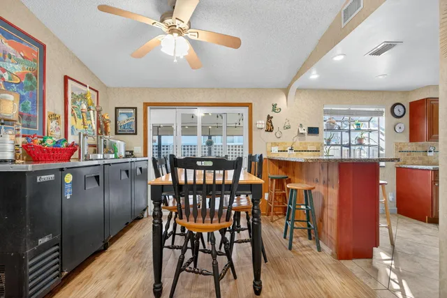 a kitchen with stainless steel appliances granite countertop a stove top oven a refrigerator and a sink