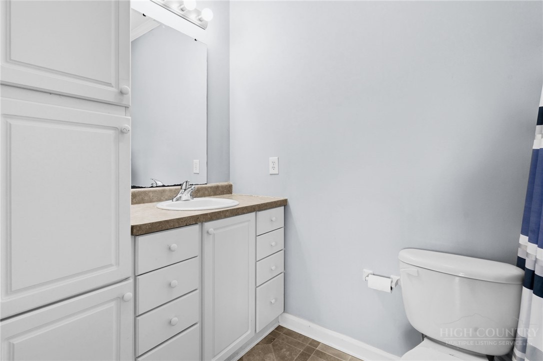 211 Cecil Miller Road, Unit 9 Boone, NC 28607 - Photo 19 of 32 a bathroom with a granite countertop toilet and sink