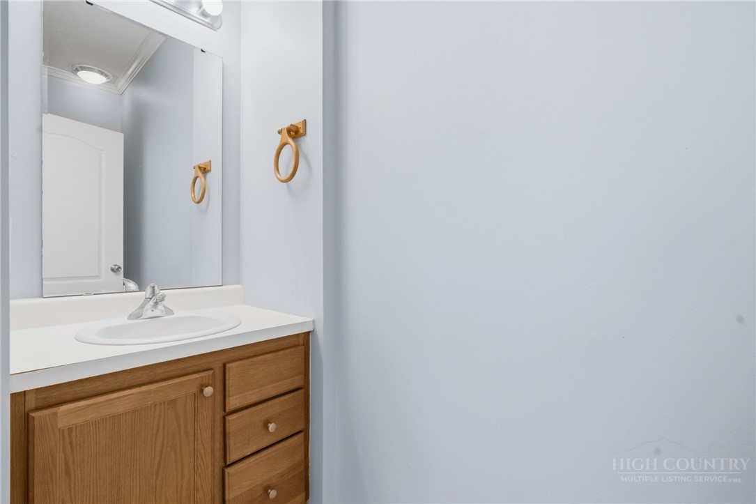 211 Cecil Miller Road, Unit 9 Boone, NC 28607 - Photo 22 of 32 a bathroom with a sink vanity and mirror