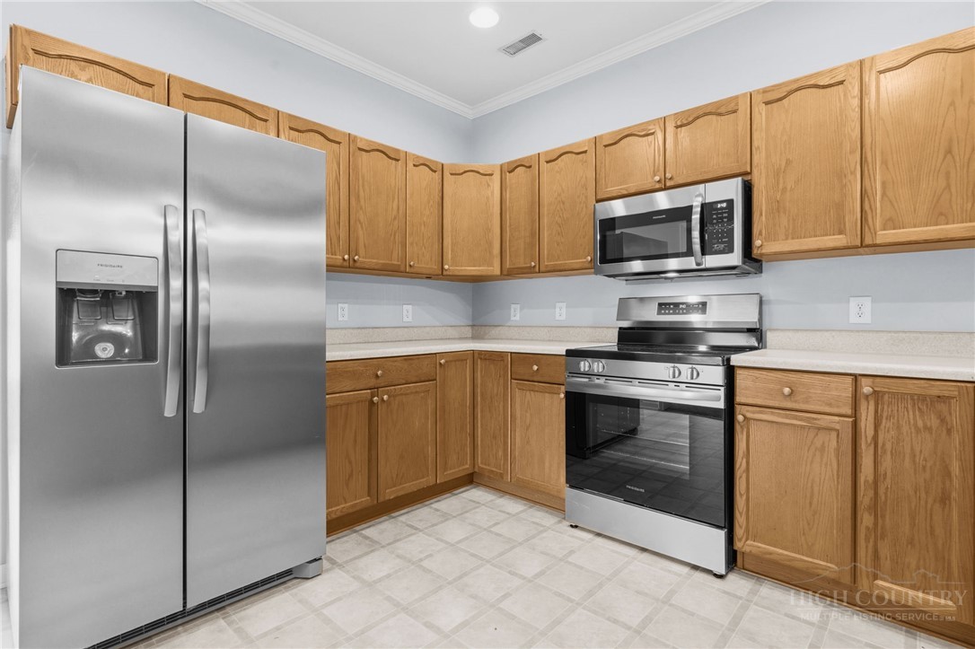 211 Cecil Miller Road, Unit 9 Boone, NC 28607 - Photo 7 of 32 a kitchen with stainless steel appliances granite countertop a refrigerator a sink a stove top oven and cabinets