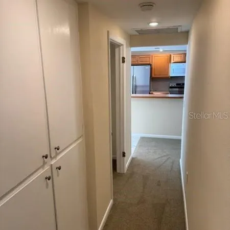 a view of a hallway with a kitchen
