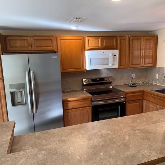 2154 Cedar Drive Dunedin, FL 34698 - Photo 4 of 19 a kitchen with a refrigerator and a sink