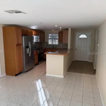 a kitchen with stainless steel appliances granite countertop a refrigerator and a sink