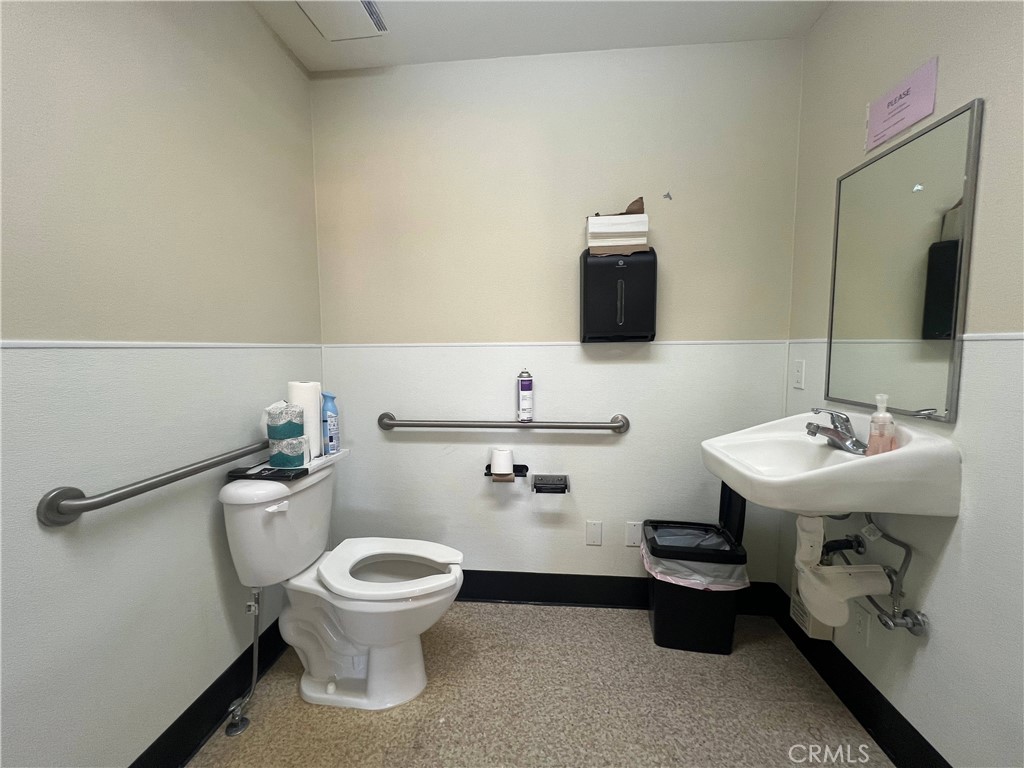 16070 Tuscola Road, Unit 203 Apple Valley, CA 92307 - Photo 8 of 14 a bathroom with a sink a toilet and mirror