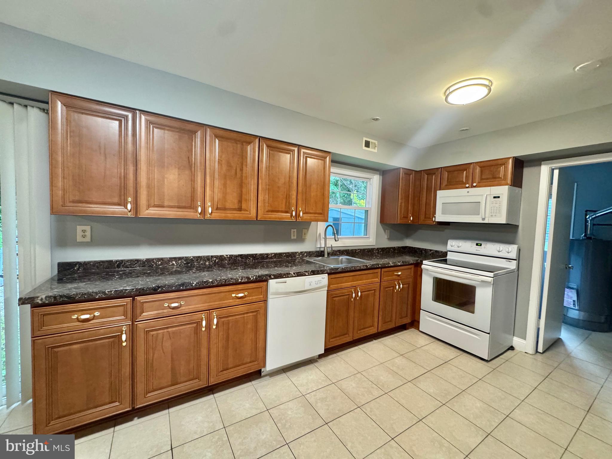 4908 Rocky Spring Lane Bowie, MD 20715 - Photo 11 of 36 a kitchen with stainless steel appliances granite countertop a stove a sink dishwasher and a refrigerator