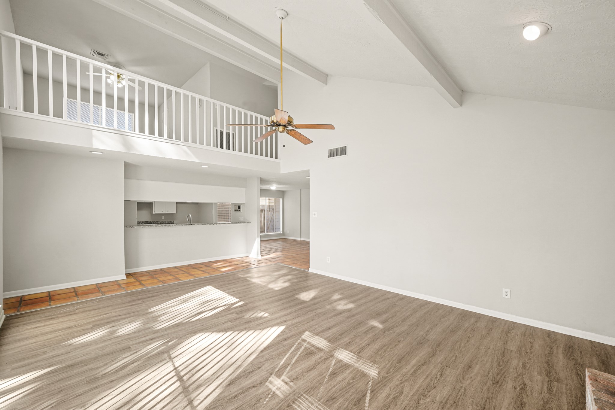 6514 Winkleman Road Houston, TX 77083 - Photo 4 of 15 a view of a big room with wooden floor and staircase