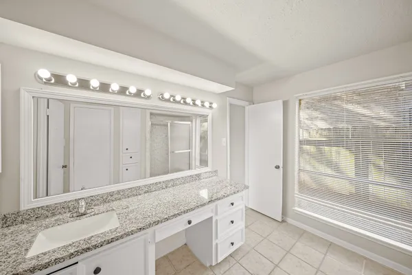 a bathroom with a granite countertop sink mirror and