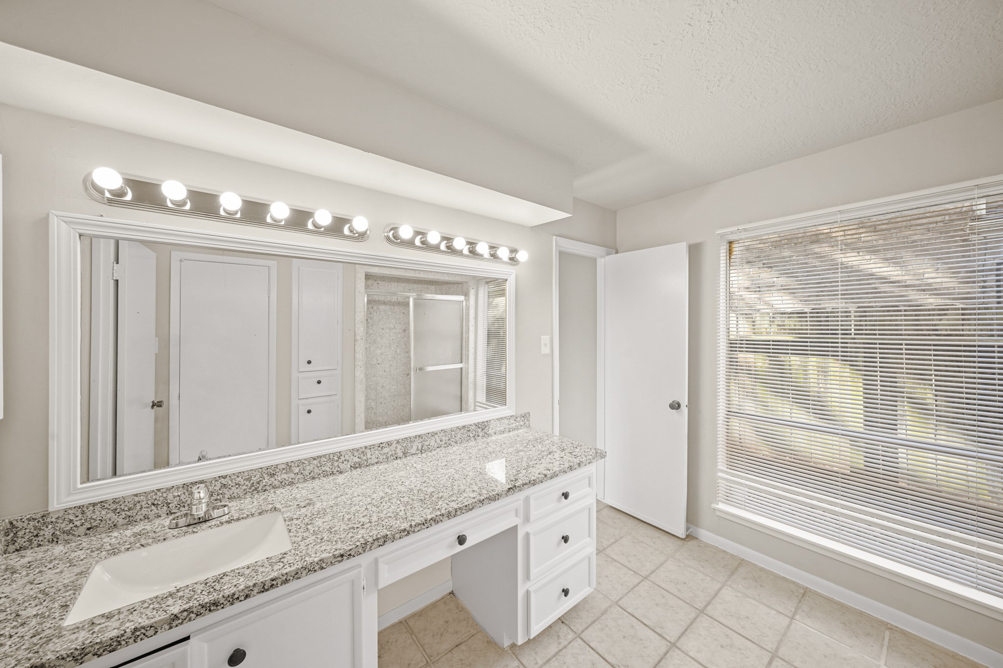 6514 Winkleman Road Houston, TX 77083 - Photo 7 of 15 a bathroom with a granite countertop sink mirror and