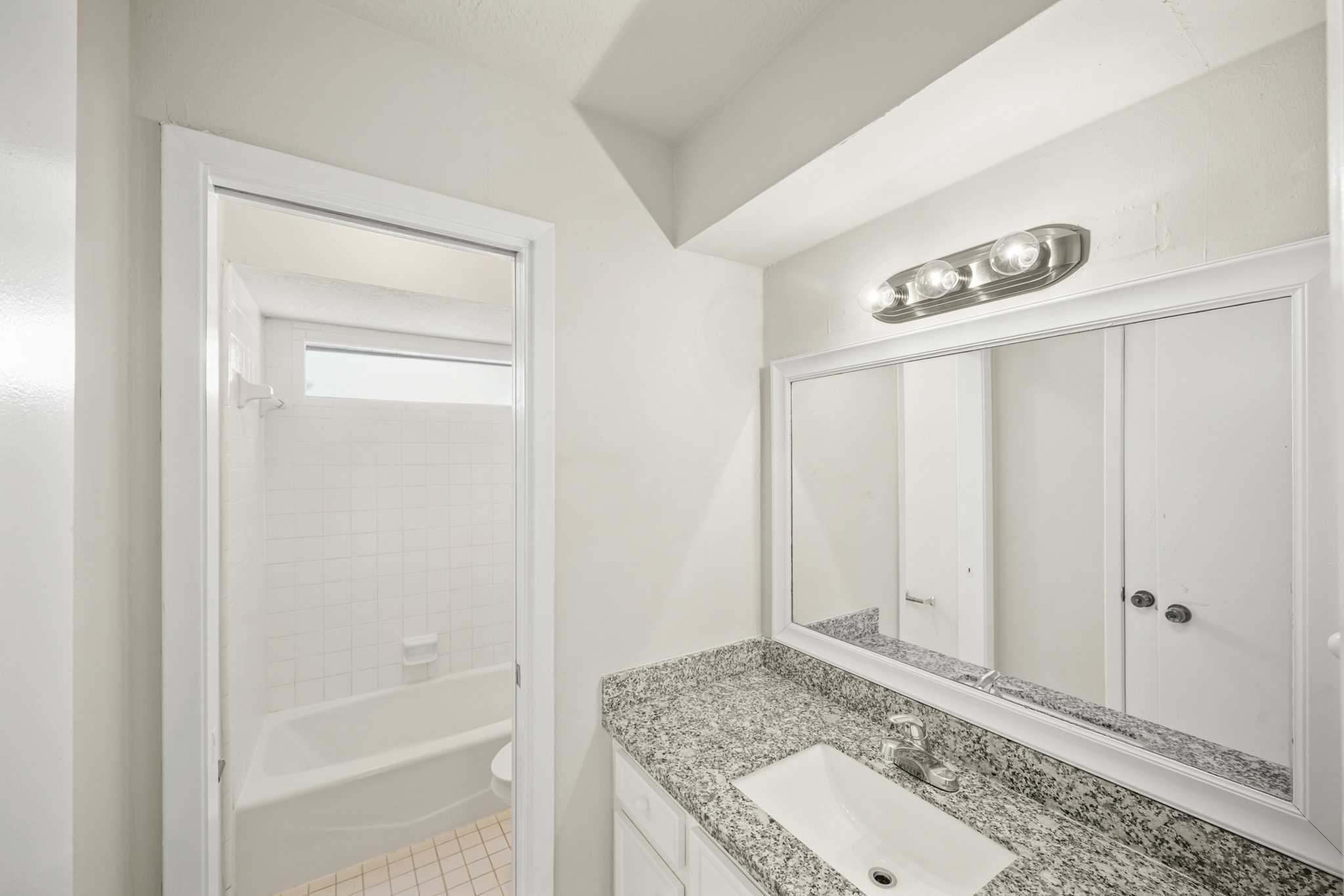 6514 Winkleman Road Houston, TX 77083 - Photo 9 of 15 a bathroom with a granite countertop sink and a mirror