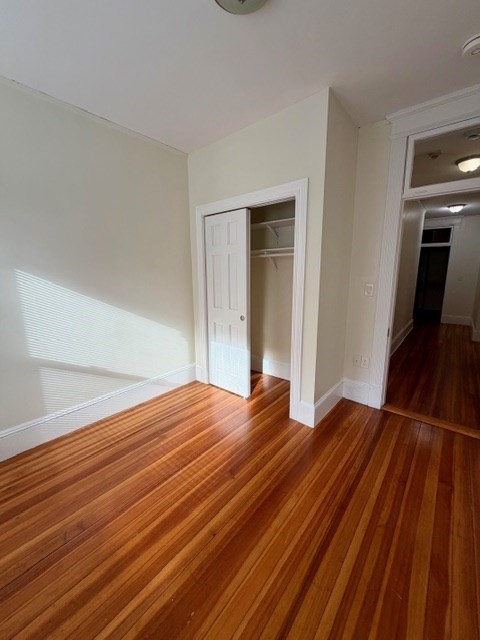 5 Winchester Street, Unit 201 Brookline, MA 02446 - Photo 11 of 14 a bedroom with a bed and wooden floor