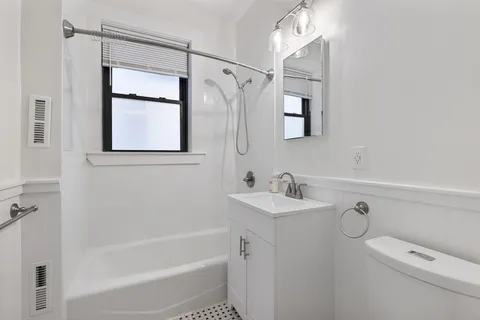a bathroom with a shower a sink and a mirror