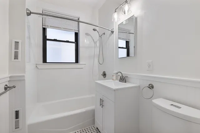 a bathroom with a shower a sink and a mirror