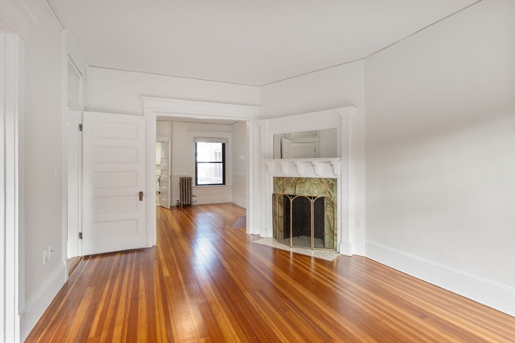 5 Winchester Street, Unit 201 Brookline, MA 02446 - Photo 4 of 14 a view of an empty room with wooden floor and a window