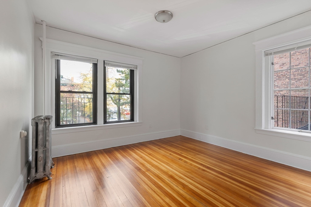 5 Winchester Street, Unit 201 Brookline, MA 02446 - Photo 8 of 14 a view of an empty room with wooden floor and a window