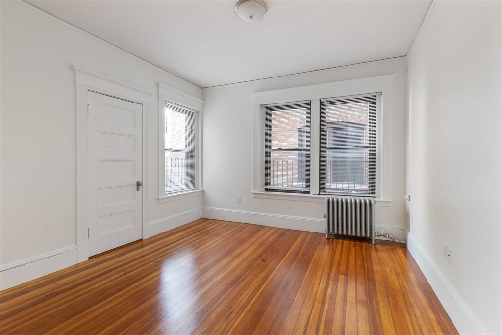 5 Winchester Street, Unit 201 Brookline, MA 02446 - Photo 9 of 14 wooden floor in an empty room with a window
