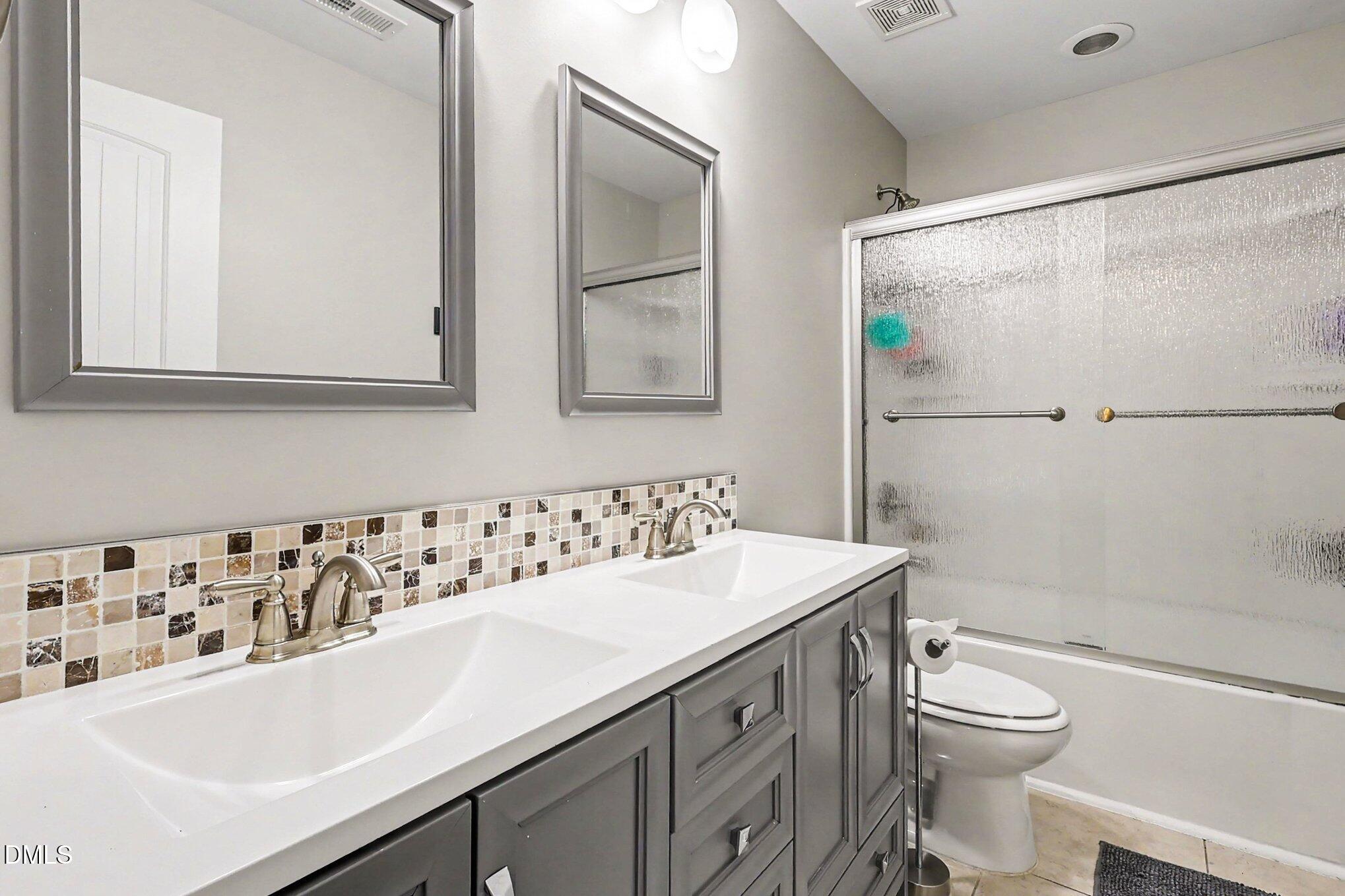 4366 Auburn Hills Drive Raleigh, NC 27616 - Photo 28 of 40 a bathroom with a sink a toilet and shower