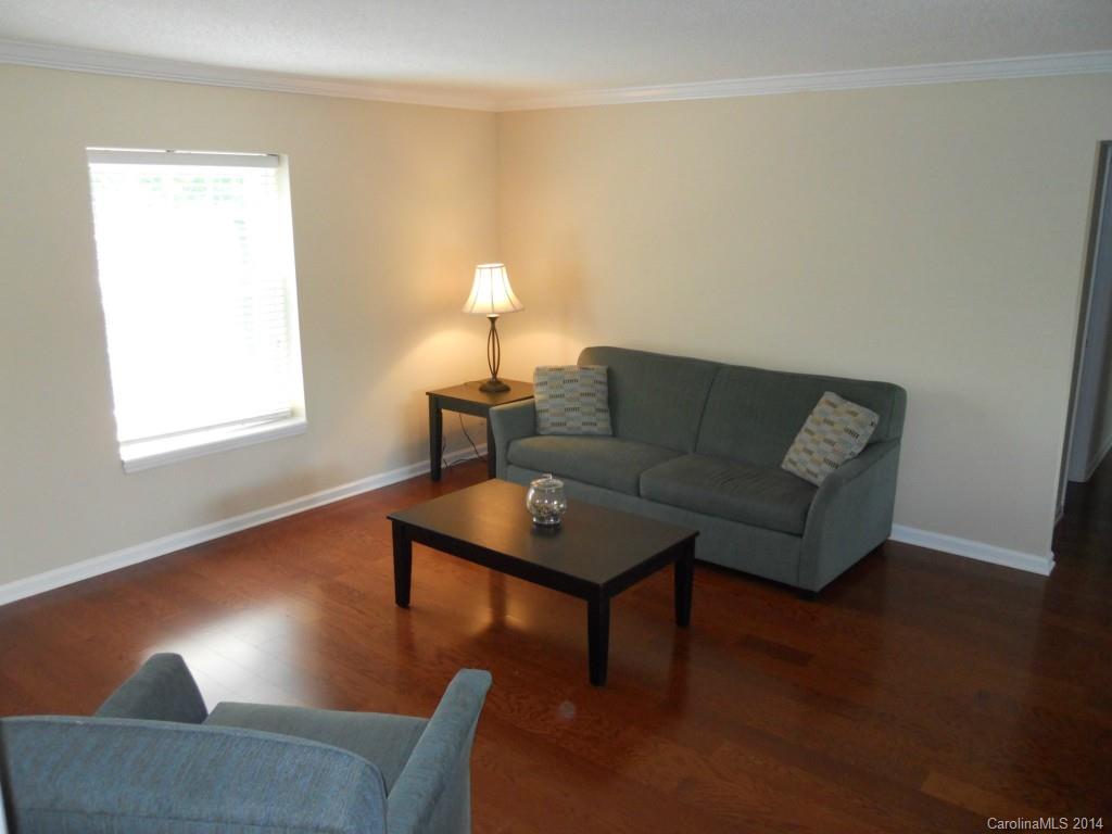 2632 Park Road, Unit H Charlotte, NC 28209 - Photo 2 of 23 a living room with furniture and a wooden floor