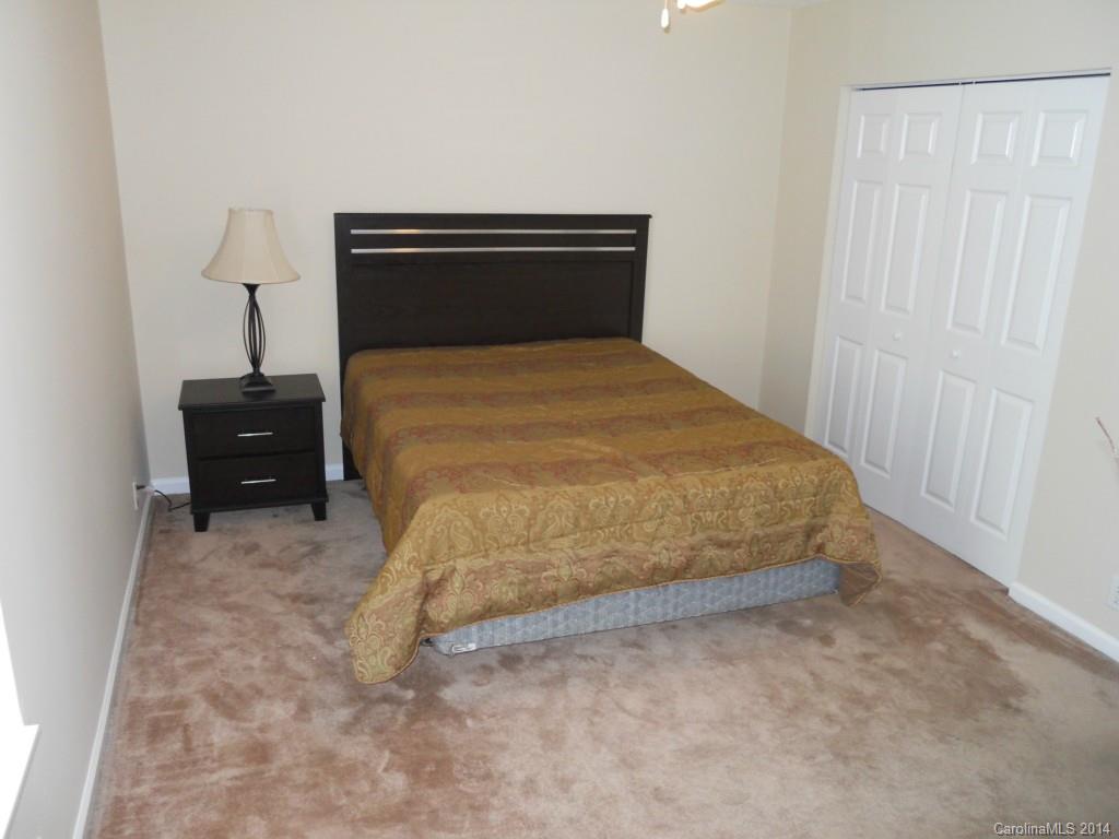 2632 Park Road, Unit H Charlotte, NC 28209 - Photo 13 of 23 a bedroom with a bed and a table