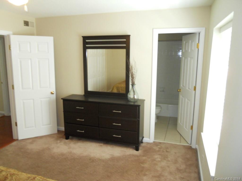 2632 Park Road, Unit H Charlotte, NC 28209 - Photo 14 of 23 a room with a mirror and a dresser
