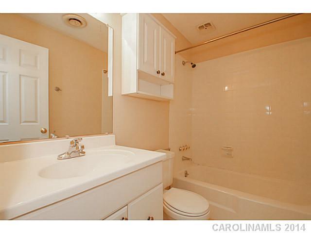 2632 Park Road, Unit H Charlotte, NC 28209 - Photo 16 of 23 a bathroom with a sink a toilet and shower