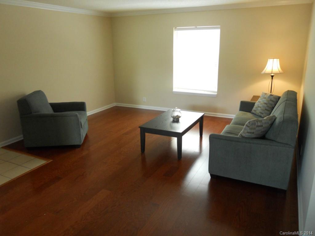 2632 Park Road, Unit H Charlotte, NC 28209 - Photo 3 of 23 a living room with couches and a coffee table with wooden floor
