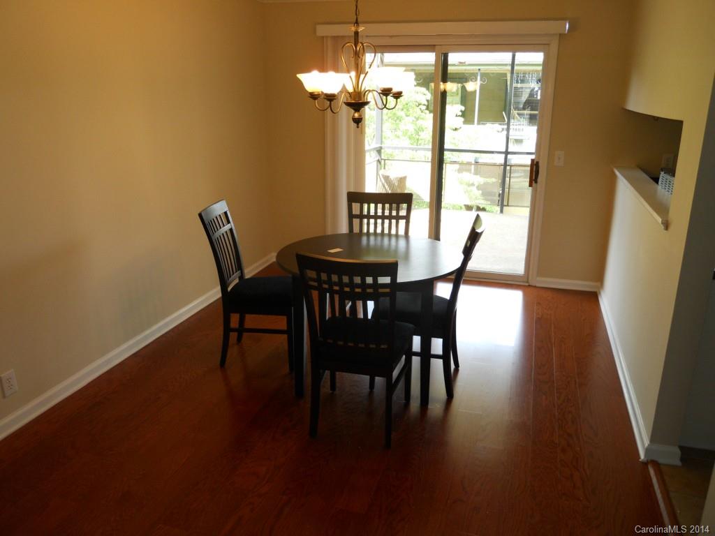 2632 Park Road, Unit H Charlotte, NC 28209 - Photo 5 of 23 a view of a dining room with furniture window and wooden floor