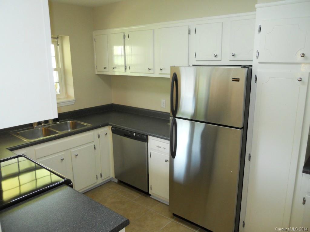 2632 Park Road, Unit H Charlotte, NC 28209 - Photo 9 of 23 a kitchen with a refrigerator and cabinets