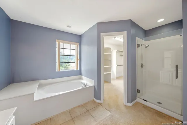 a spacious bathroom with a bathtub and a shower