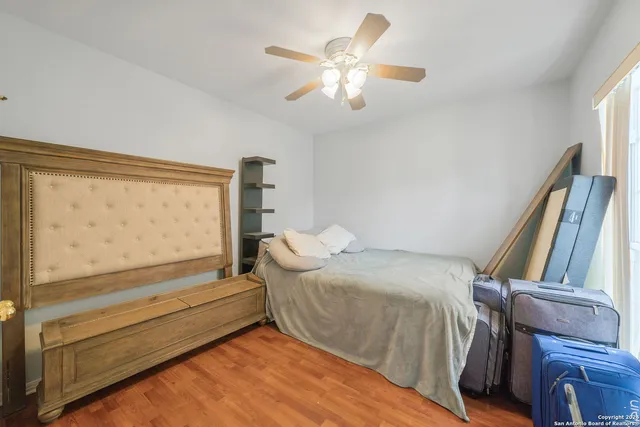 a bedroom with a bed and a large window