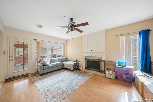 a living room with furniture fireplace and flat screen tv