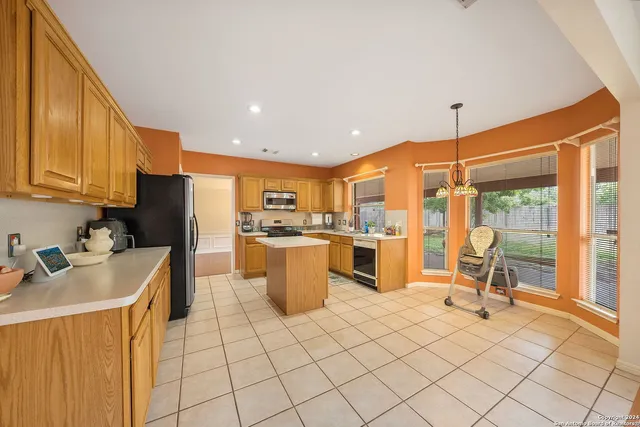 a kitchen with a sink appliances and cabinets