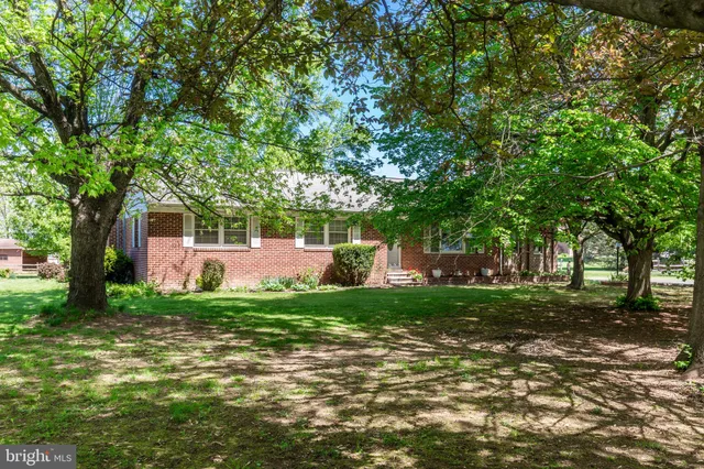 a front view of a house with a yard table and chairs