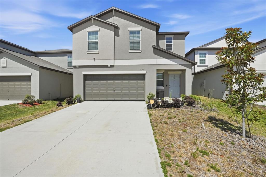13712 Newbridge Street Spring Hill, FL 34609 - Photo 1 of 35 a front view of a house with a yard