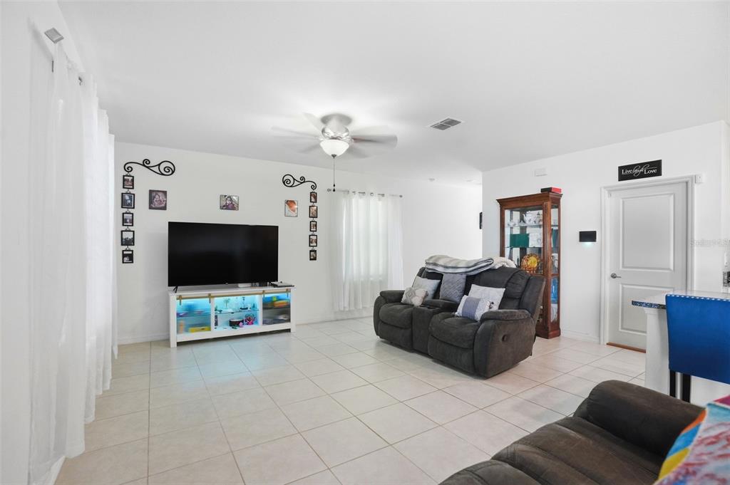 13712 Newbridge Street Spring Hill, FL 34609 - Photo 12 of 35 a living room with furniture and a flat screen tv