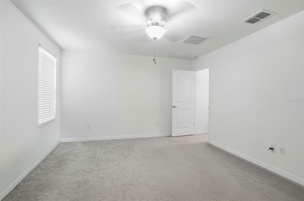 13712 Newbridge Street Spring Hill, FL 34609 - Photo 17 of 35 an empty room with a window and a chandelier fan
