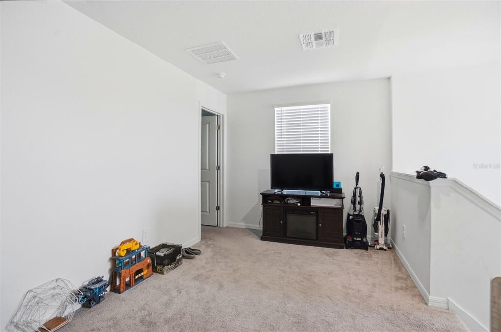 13712 Newbridge Street Spring Hill, FL 34609 - Photo 19 of 35 a livingroom with furniture and a flat screen tv