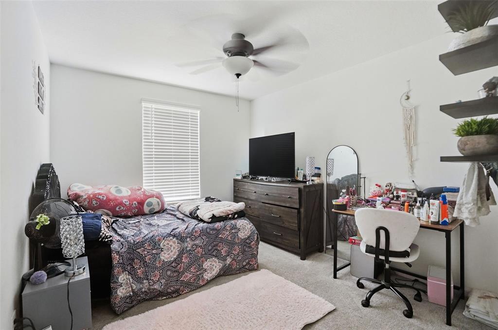 13712 Newbridge Street Spring Hill, FL 34609 - Photo 22 of 35 a bedroom with a bed and flat screen tv