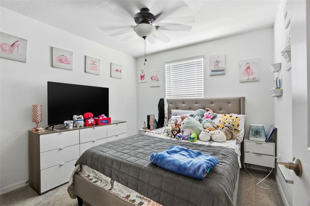 13712 Newbridge Street Spring Hill, FL 34609 - Photo 23 of 35 a bedroom with a bed and flat screen tv