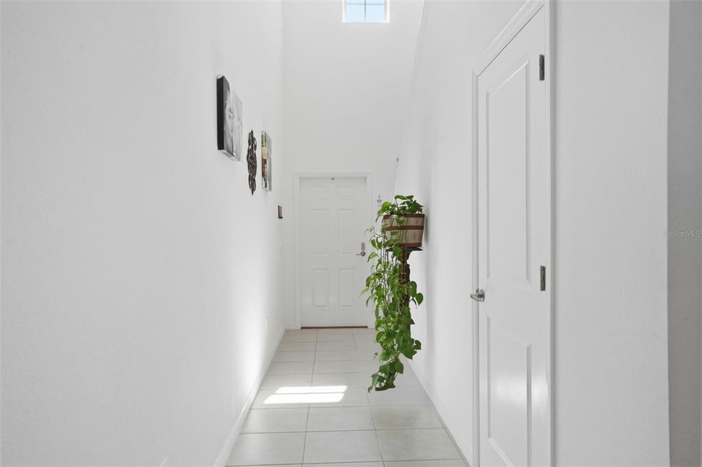 13712 Newbridge Street Spring Hill, FL 34609 - Photo 28 of 35 a view of a hallway with a potted plant