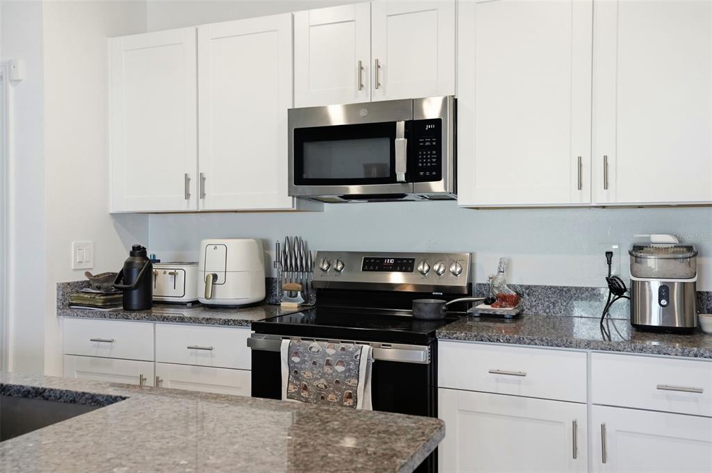 13712 Newbridge Street Spring Hill, FL 34609 - Photo 9 of 35 a kitchen with appliances a sink and cabinets