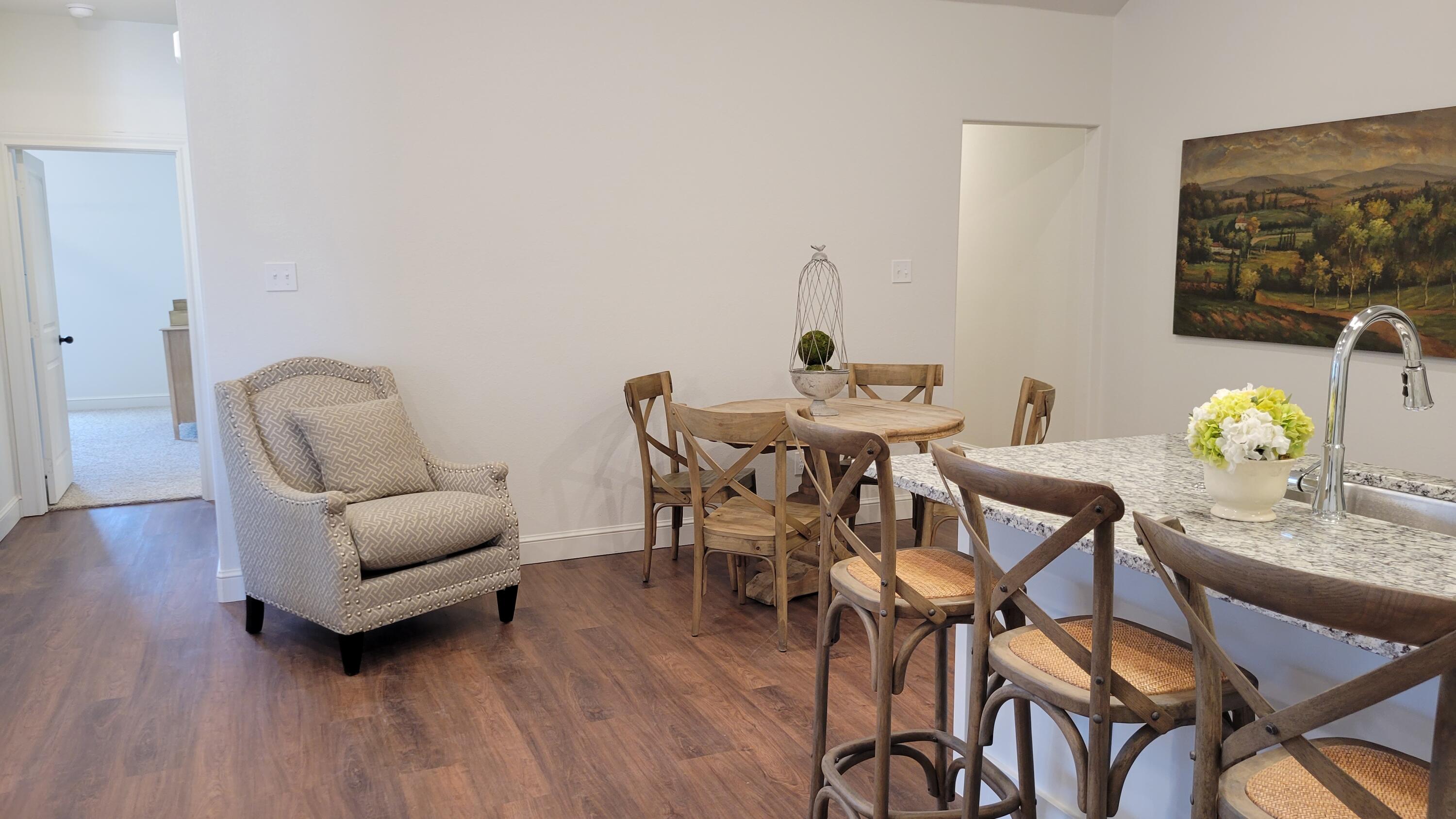 7120 22nd Street Lubbock, TX 79407 - Photo 14 of 40 a view of a dining room with furniture and wooden floor