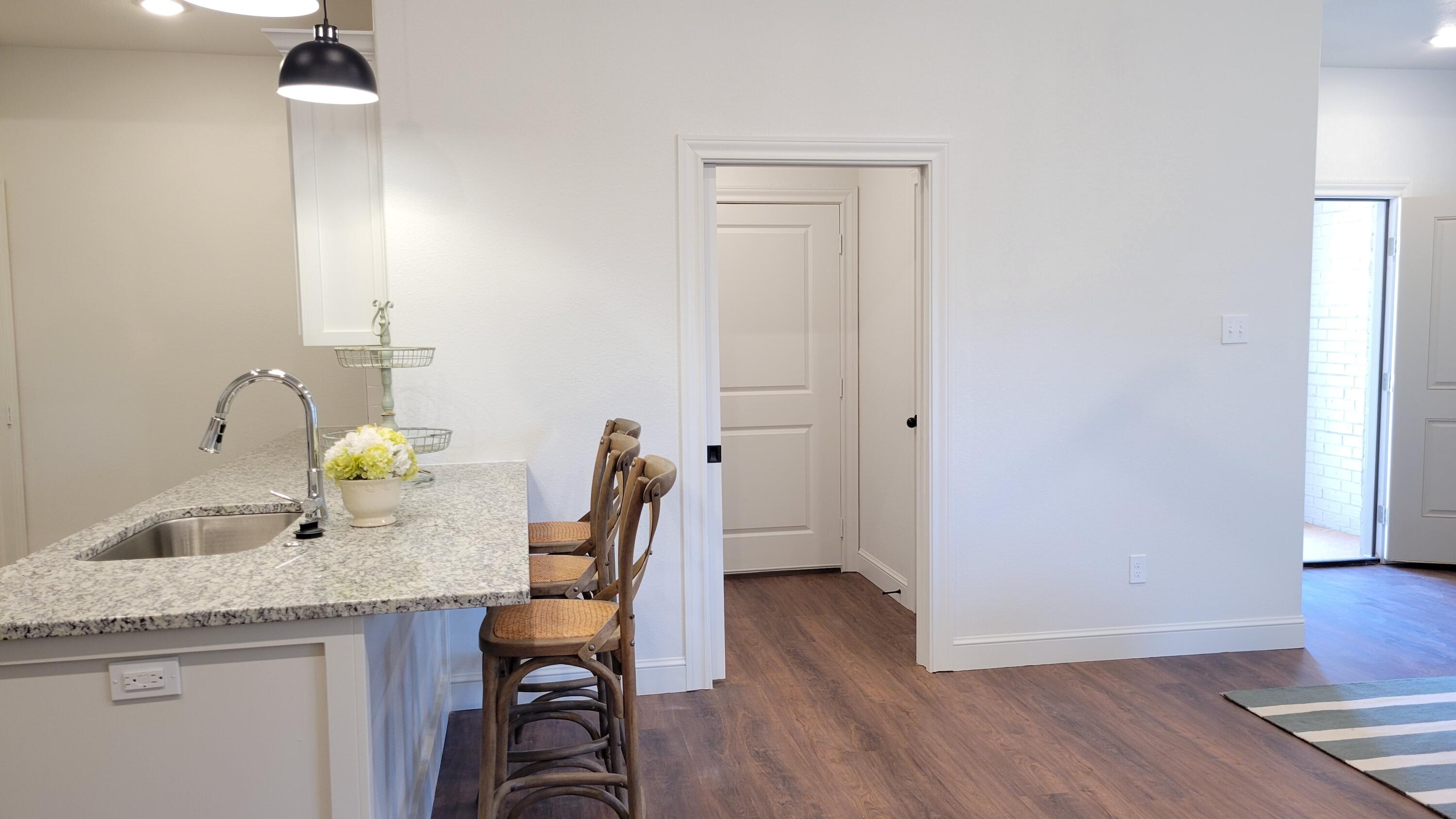 7120 22nd Street Lubbock, TX 79407 - Photo 15 of 40 a view of dining room and wooden floor