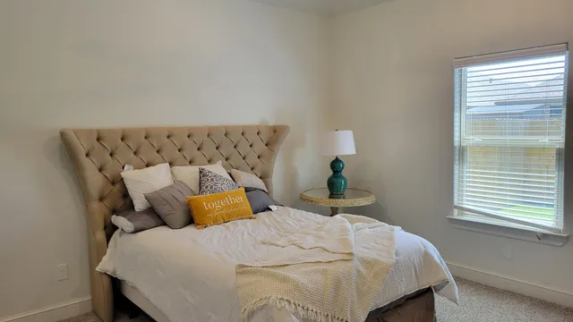 a bedroom with a bed and window