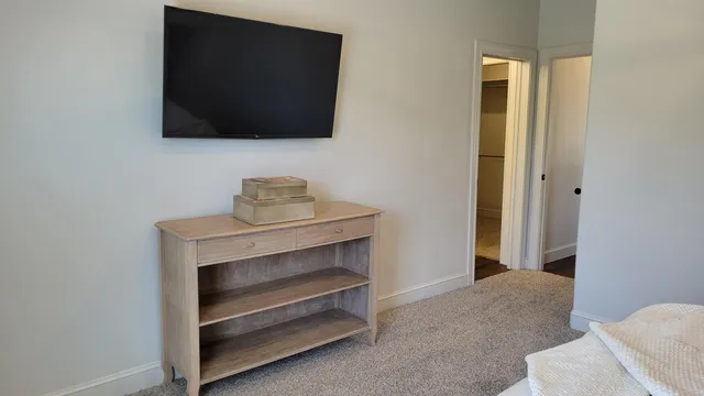 a bedroom with a bed and a flat screen tv