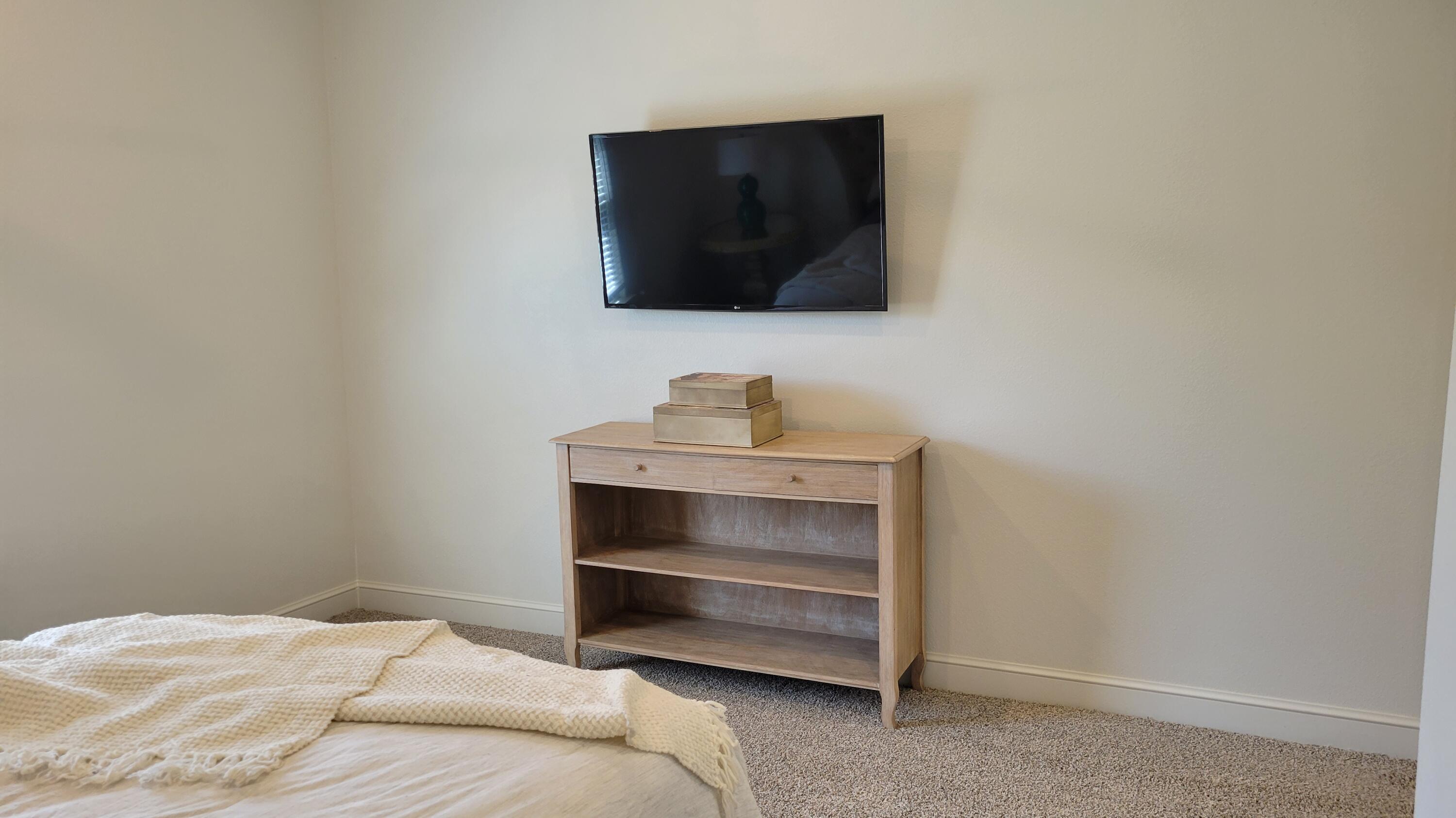 7120 22nd Street Lubbock, TX 79407 - Photo 22 of 40 a bedroom with a bed and a flat screen tv