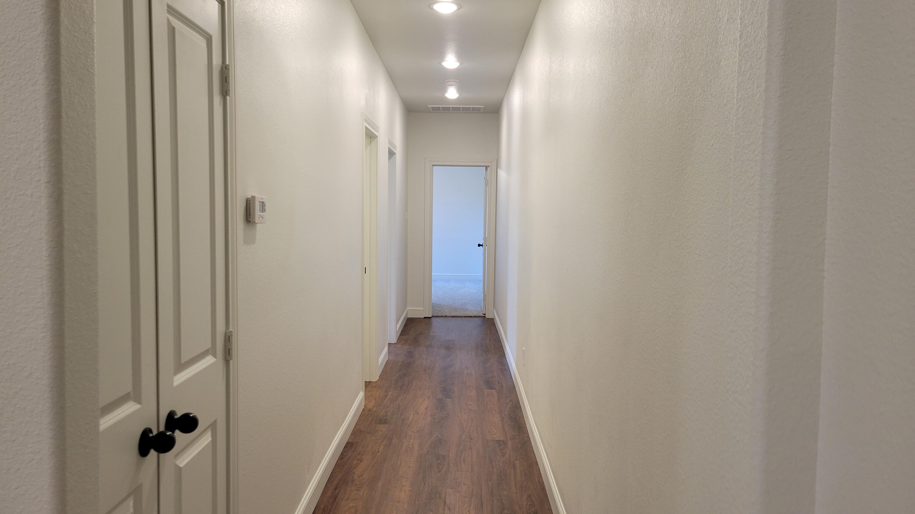 7120 22nd Street Lubbock, TX 79407 - Photo 29 of 40 a view of a hallway with wooden floor