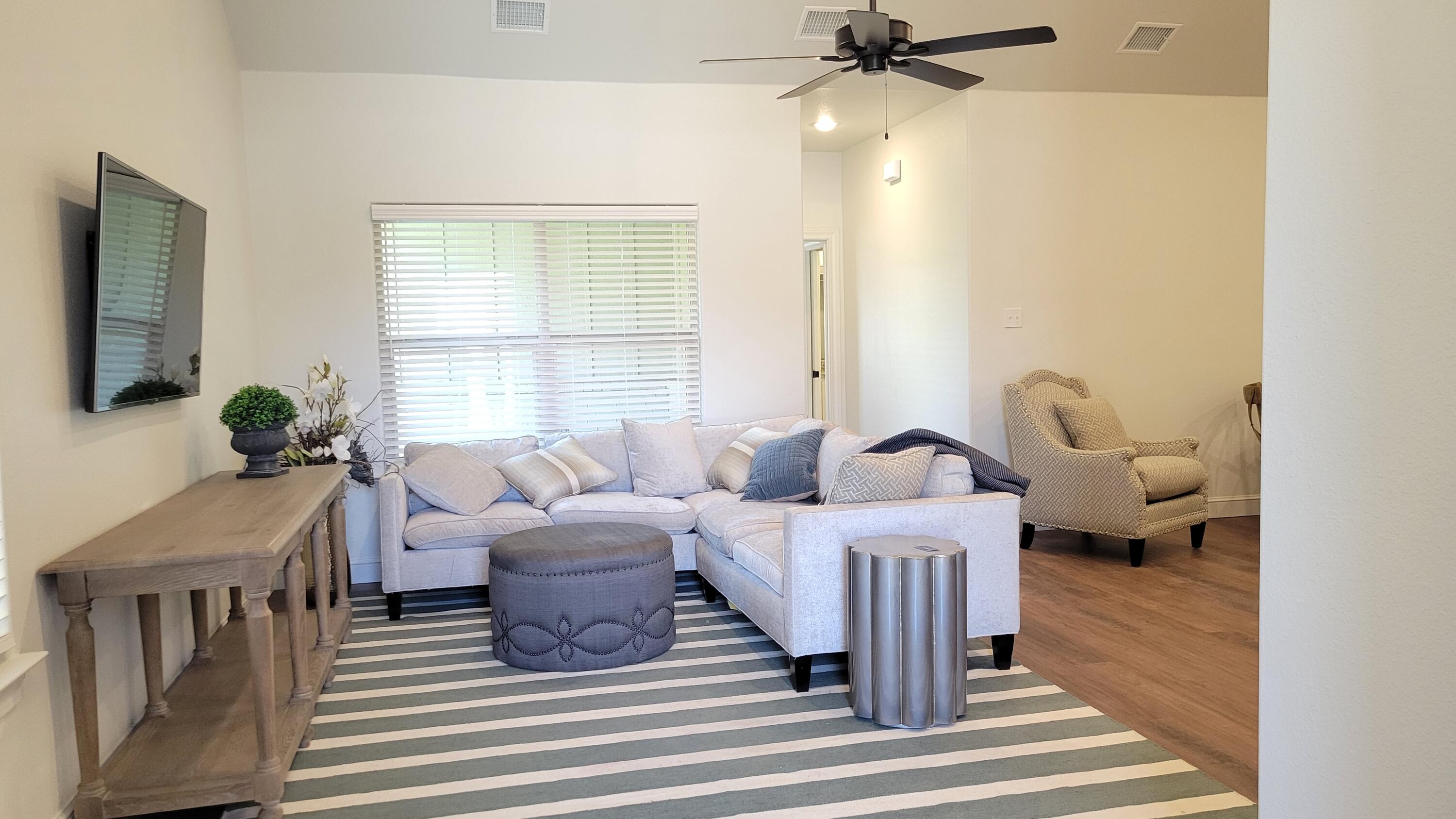 7120 22nd Street Lubbock, TX 79407 - Photo 4 of 40 a living room with furniture a chandelier and a window