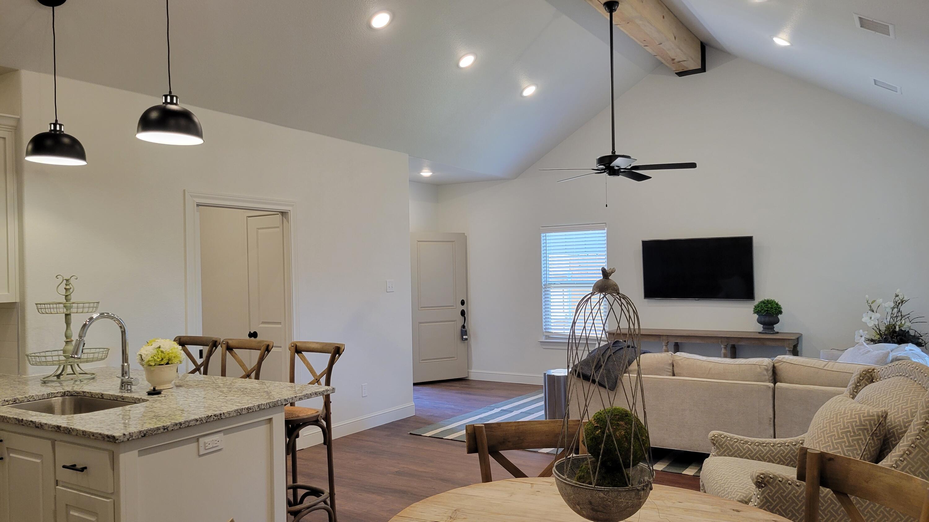7120 22nd Street Lubbock, TX 79407 - Photo 10 of 40 a living room with furniture and a flat screen tv